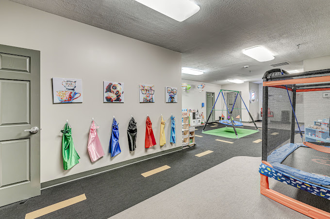 wall with capes and photos