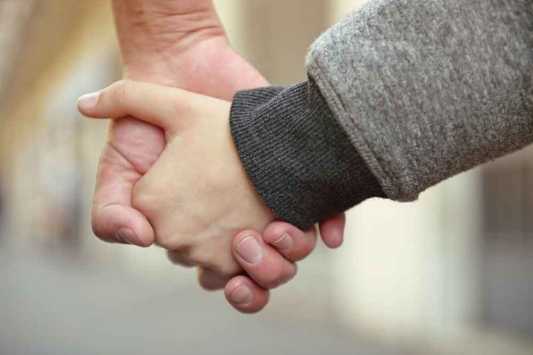 mother and son holding hands